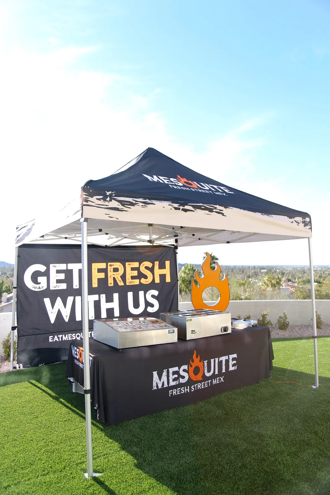 Mesquite Fresh Street Mex branded canopy tent with steam trays and a Get Fresh With Us banner set up on grass