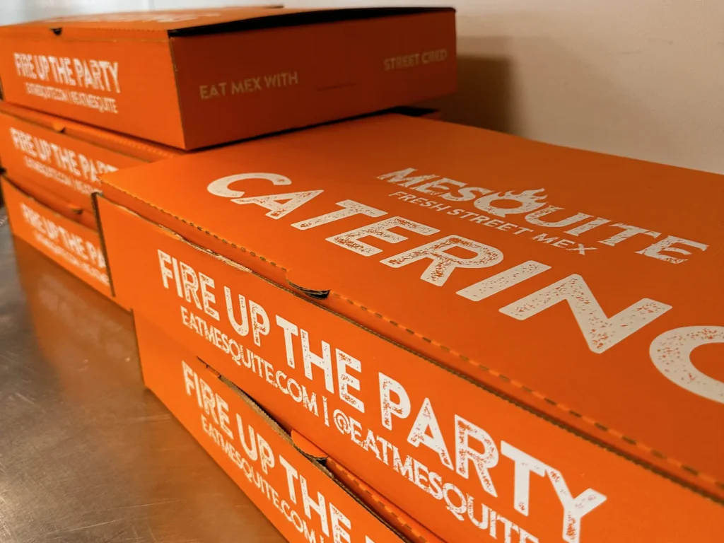Stack of Mesquite Fresh Street Mex catering boxes ready for delivery