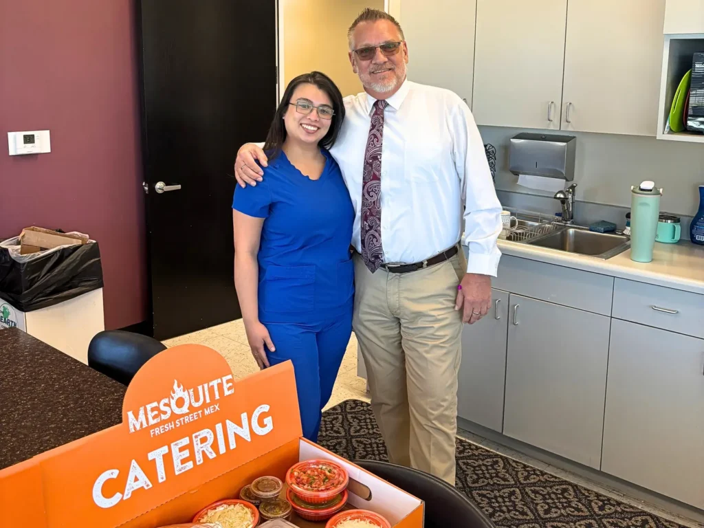 Two happy customers with their Mesquite Fresh Street Mex catering delivery at their office