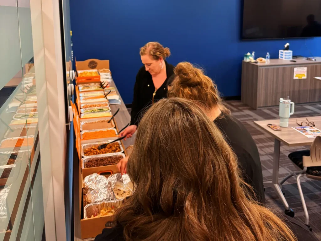 Office team lining up at a Mesquite taco bar catering spread