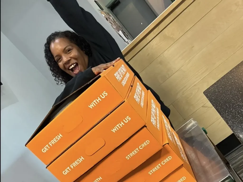 Mesquite team member with a cart of catering boxes ready for delivery