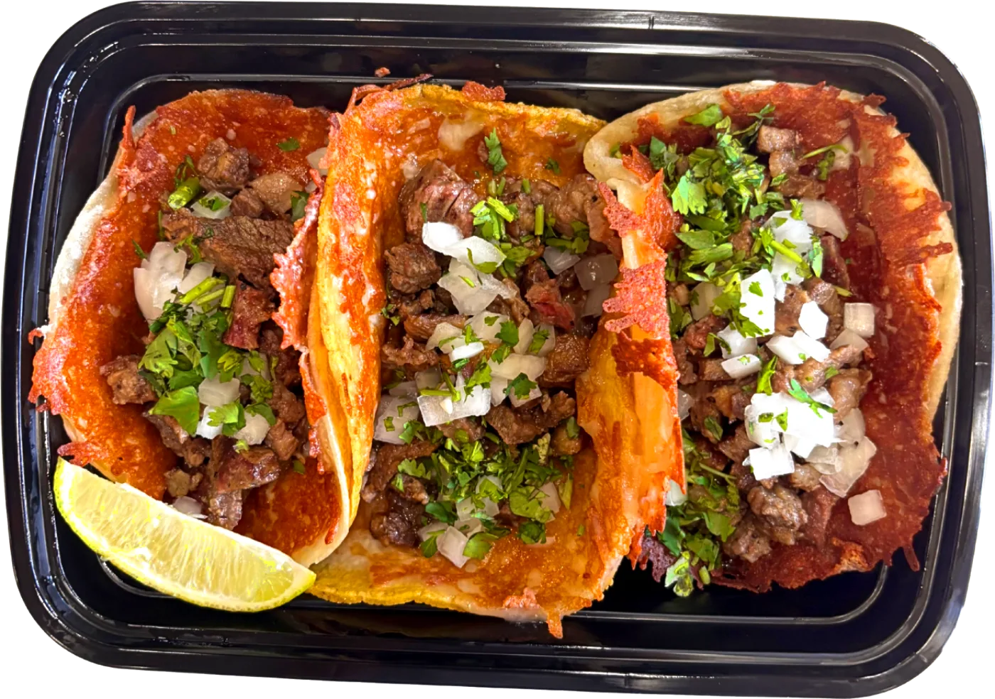 Three Vampiro Tacos in a to-go tray: crispy cheese-crusted tortillas, fire-grilled steak, onion, cilantro and a lime wedge
